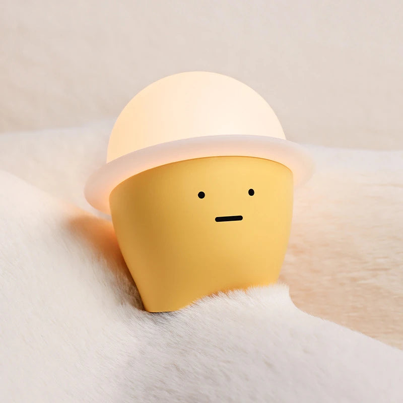 a yellow and white night light on a blanket