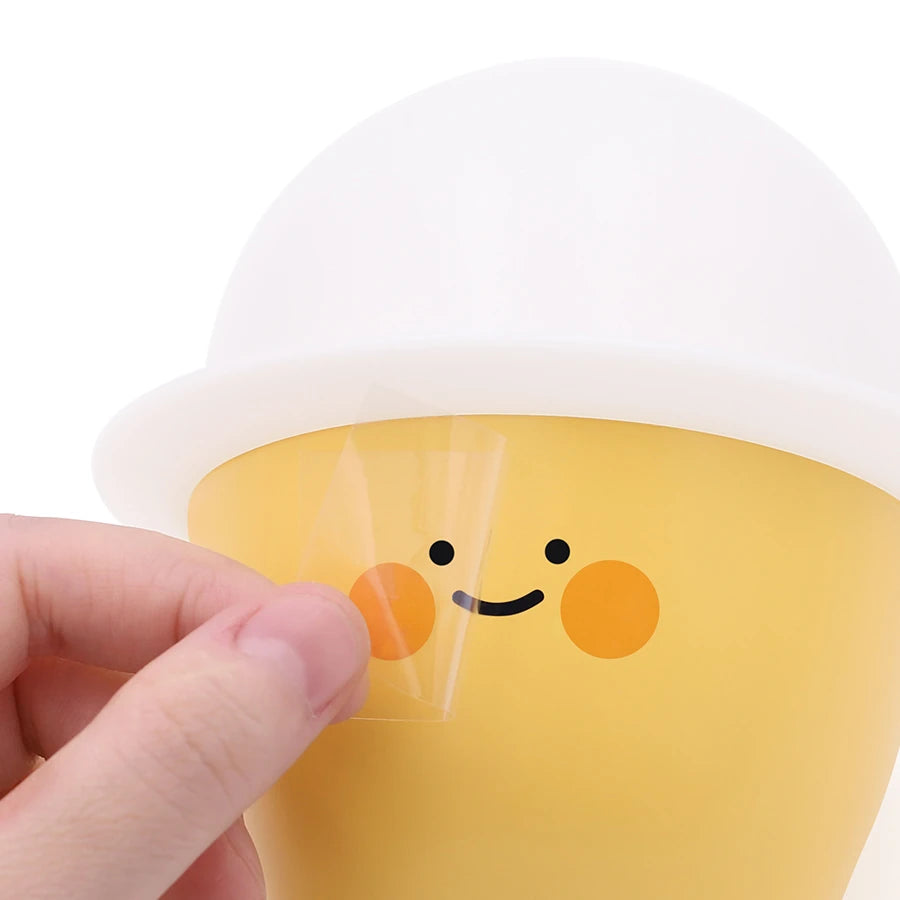 a yellow and white night light with customisable stickers