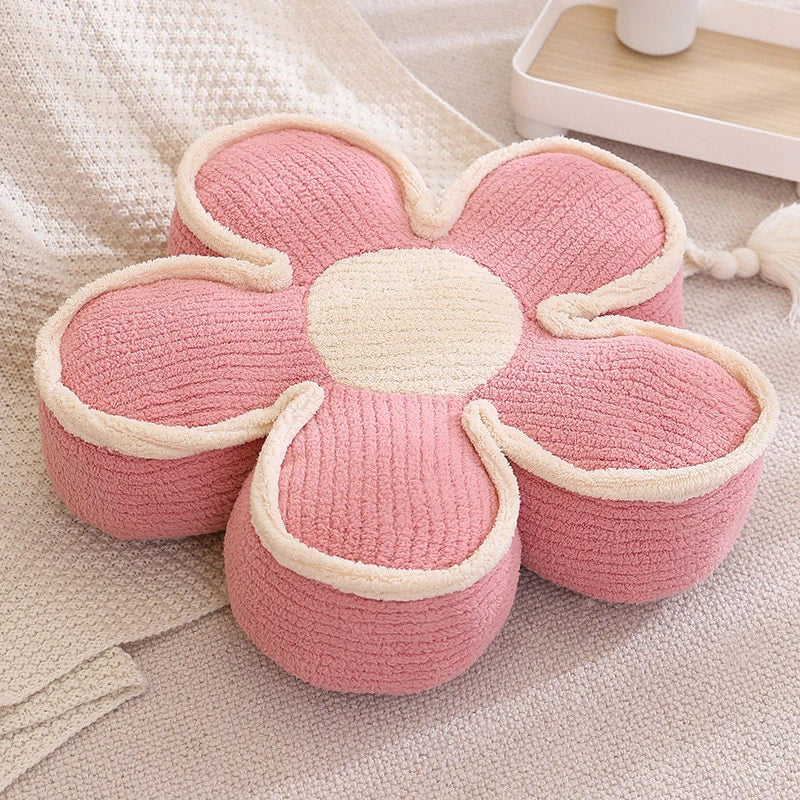 a thick pink flower cushion on the floor