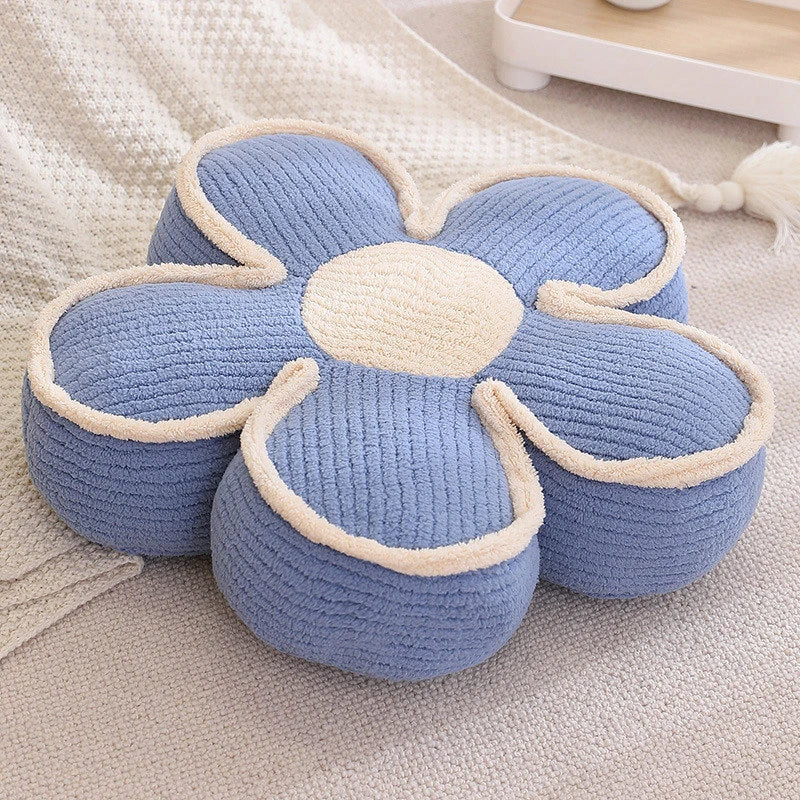 a thick blue flower cushion on the floor