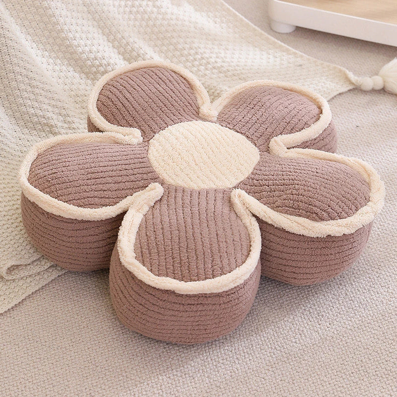 a thick brown flower cushion on the floor