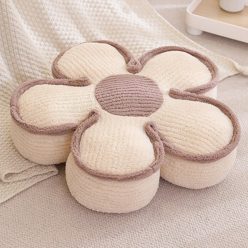 a thick cream flower cushion on the floor