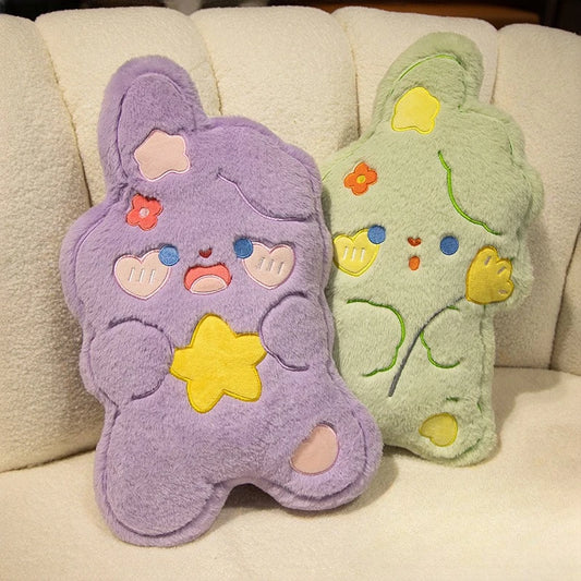 sweet, candy shaped purple and green bunny cushions with rosy cheeks, love hearts, flowers and stars on a couch