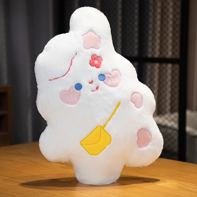 a sweet, candy shaped white bunny cushion with rosy pink love heart cheeks, flowers in its hair, and a hand bag