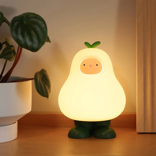 a white silicone cartoon pear night light on a bedside locker