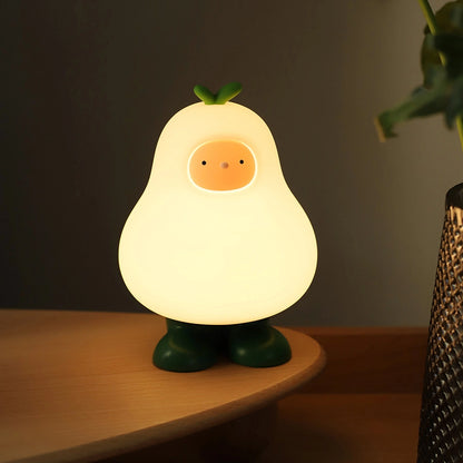 a white silicone cartoon pear night light on a bedside locker