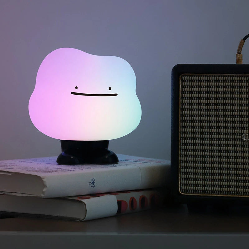 a white silicone cartoon cloud night light on a bedside locker