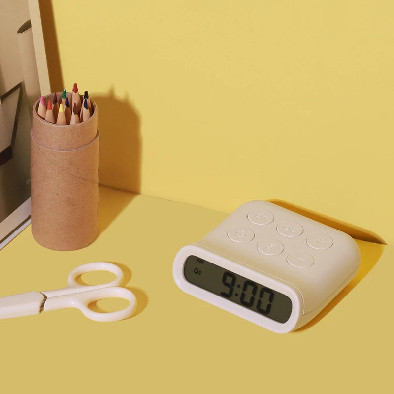 a white minimalist digital alarm clock on a desk