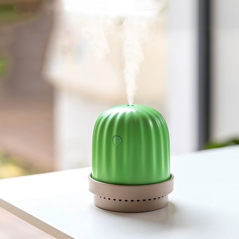 a small green cactus humidifier and night light releasing vapour