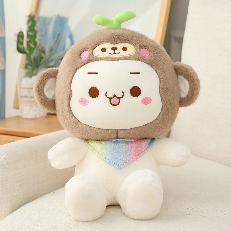 a cheeky white teddy bear wearing a rainbow kerchief and a monkey hat