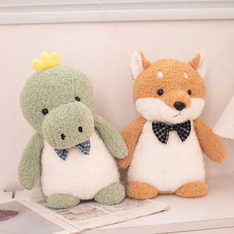 a green dinosaur soft toy wearing a dark blue bow tie and an orange shiba inu soft toy wearing a black bow tie