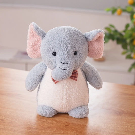 a grey elephant soft toy wearing a red bow tie