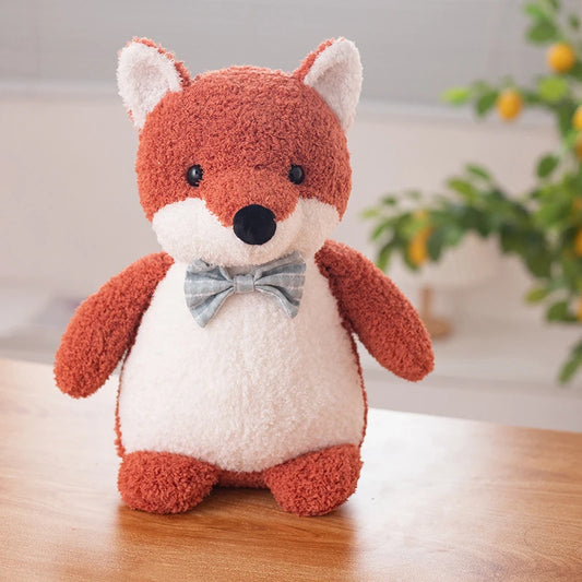 a red fox soft toy wearing a light blue bow tie