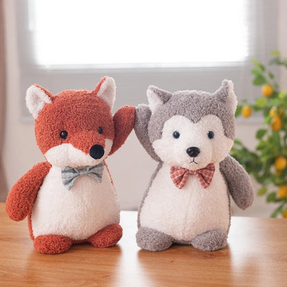 a red fox soft toy wearing a light blue bow tie high fiving a grey siberian husky soft toy wearing a red bow tie