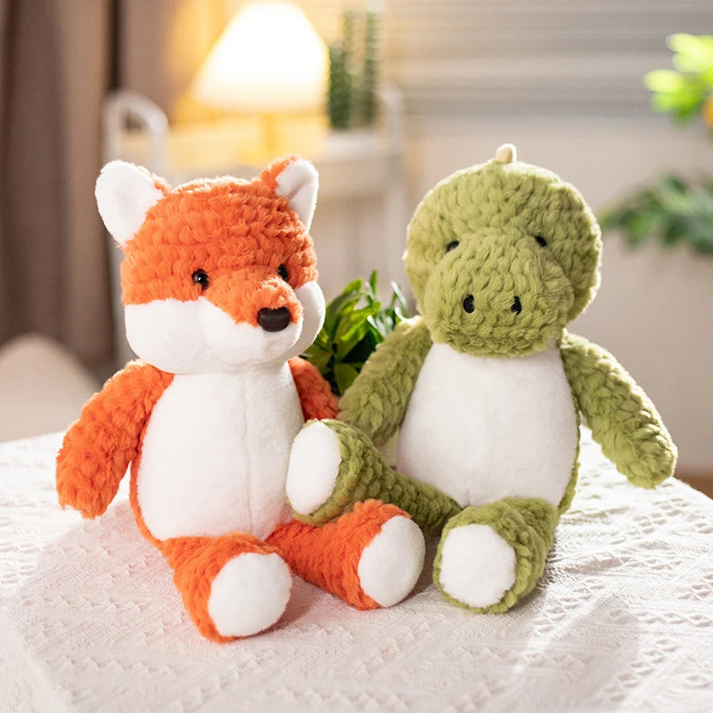 a green dinosaur soft toy and an orange fox soft toy