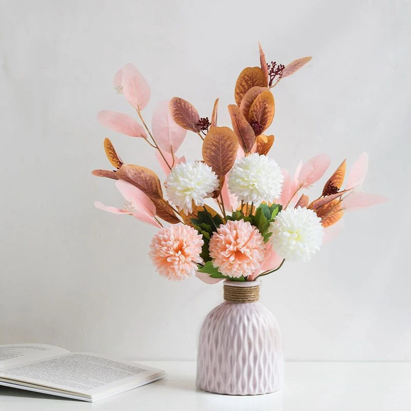 a pink vase with a ripple texture and a neck wound with yarn, shaped like a fiasco wine bottle