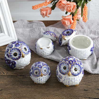 white ceramic owl incense holders with gold highlights and a blue flower pattern