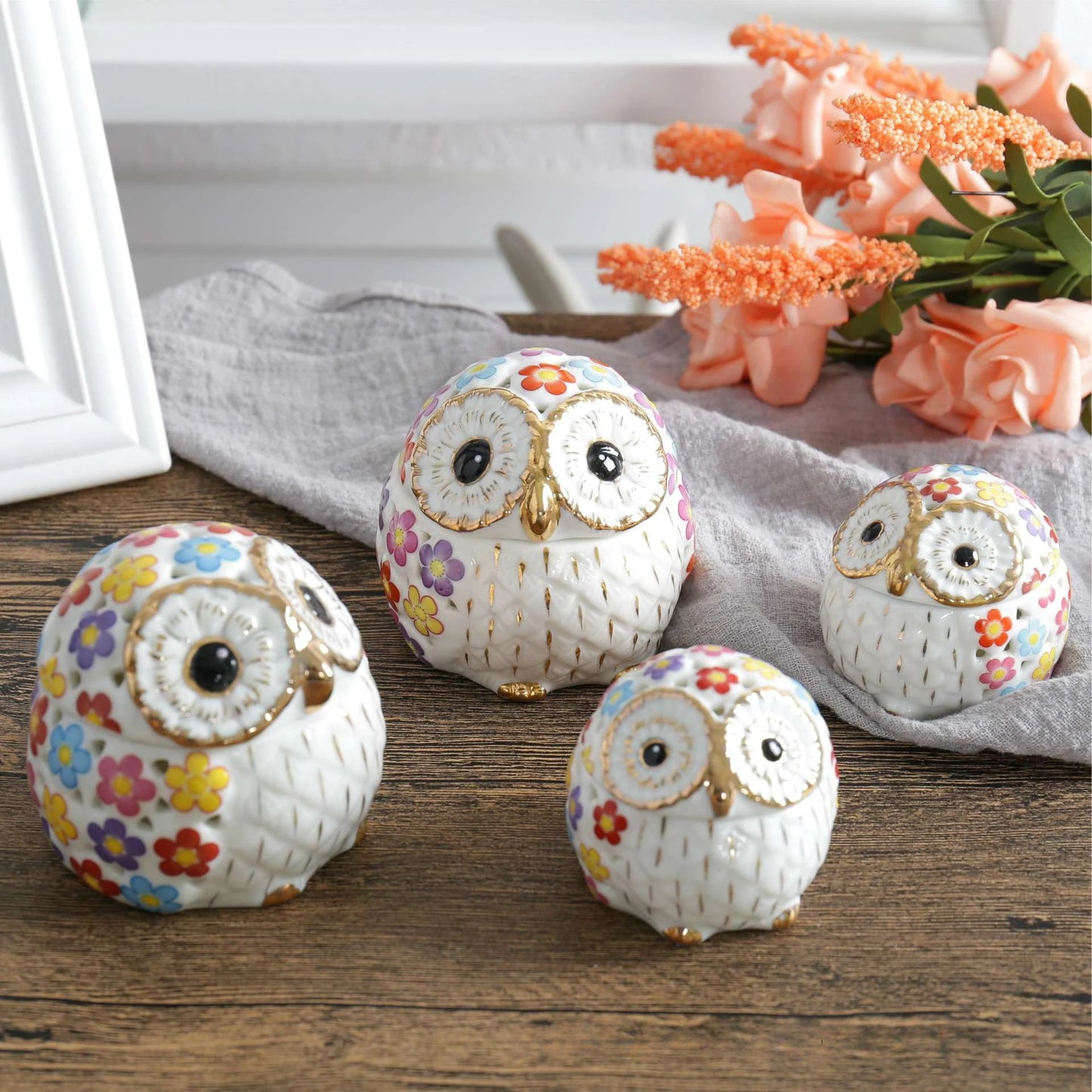 white ceramic owl incense holders with gold highlights and a pink, yellow, purple, blue, and red flower pattern