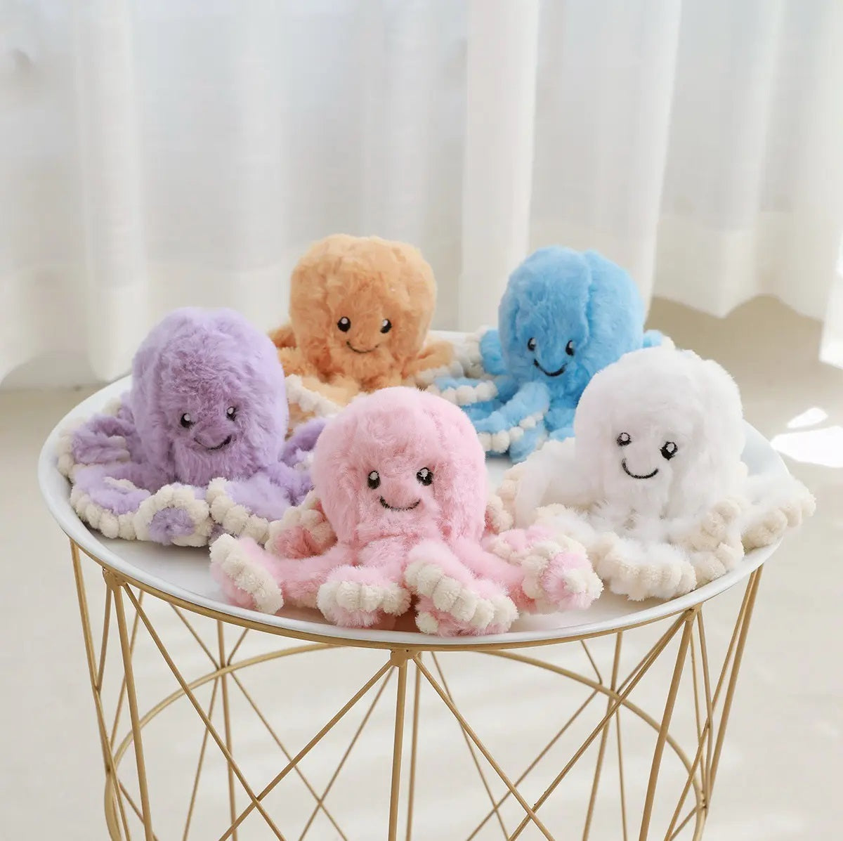 multiple small pastel coloured octopus soft toys