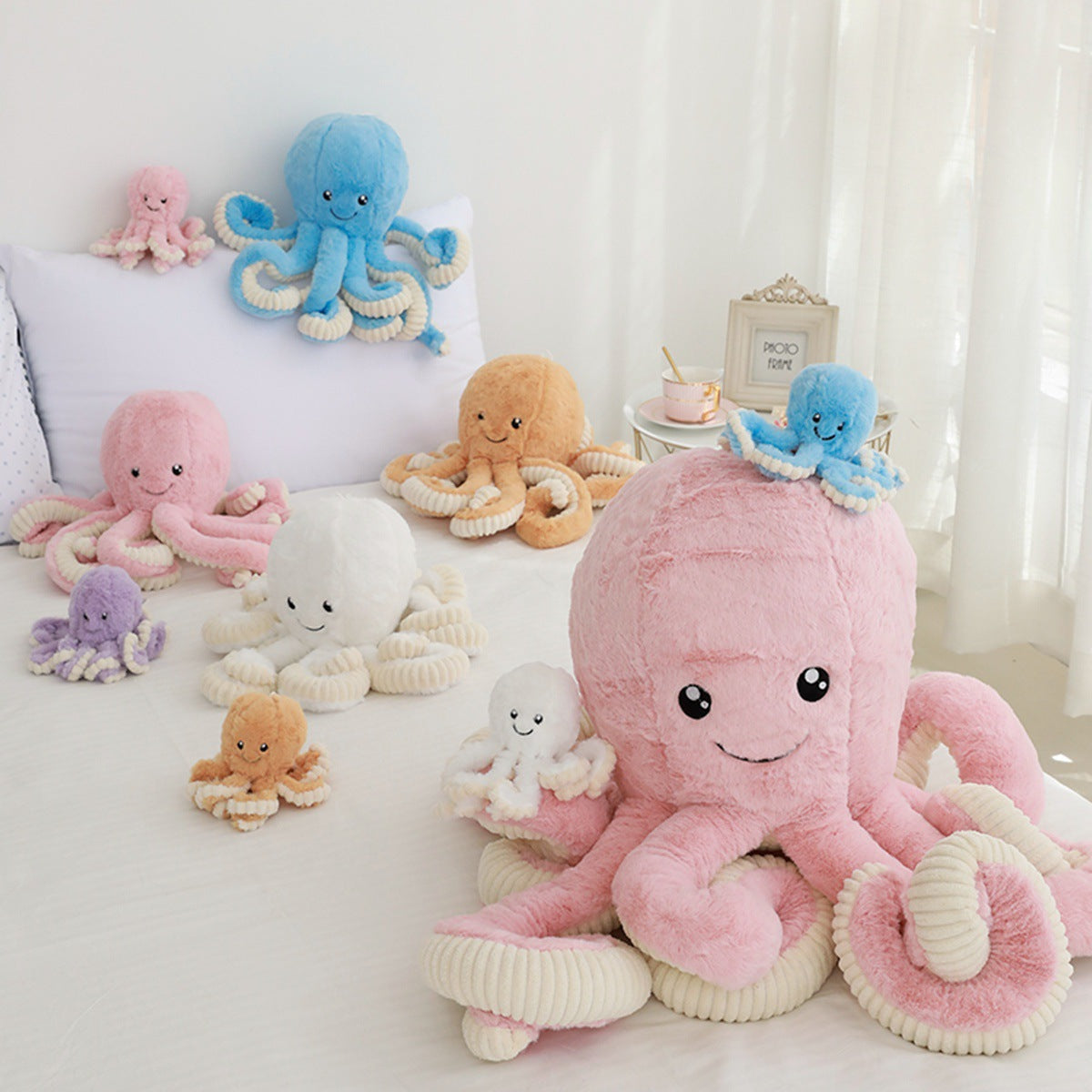 multiple different sized pastel coloured octopus soft toys