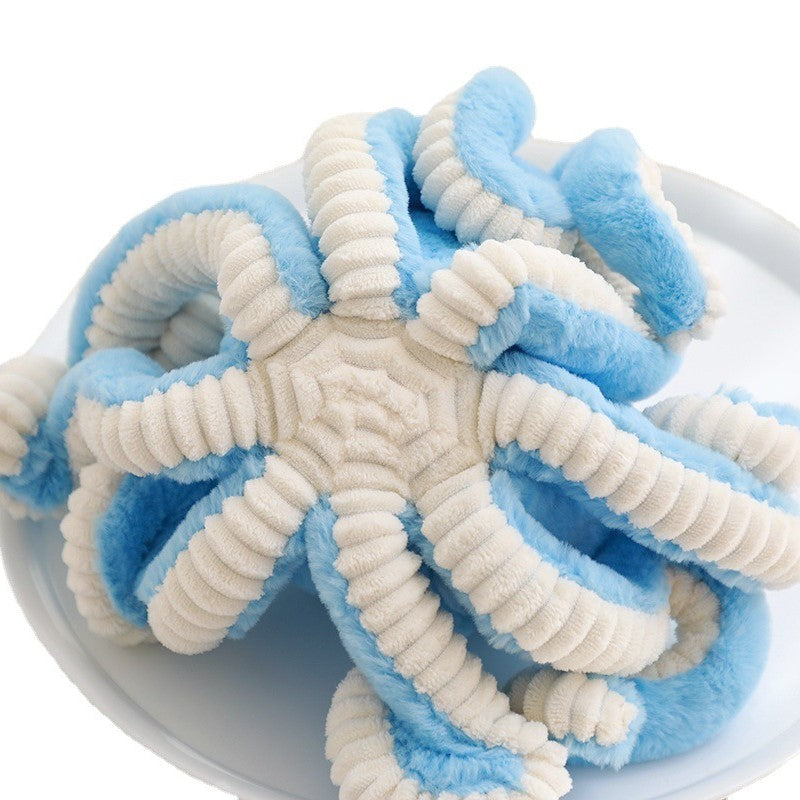 the underside of a a pastel blue octopus soft toy