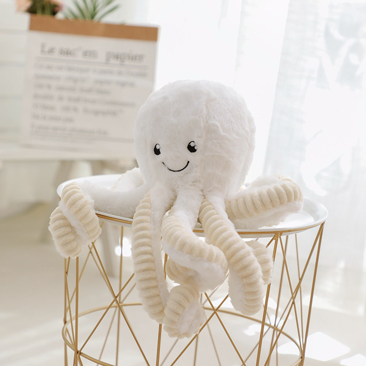 a pastel white octopus soft toy