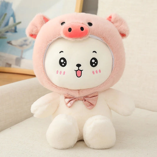 a white teddy bear wearing a pink bow tie and a pig hat