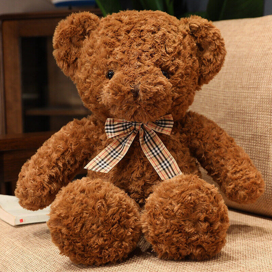 a classic chocolate brown teddy bear with a tartan bow