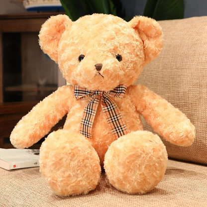 a classic toffee brown teddy bear with a tartan bow