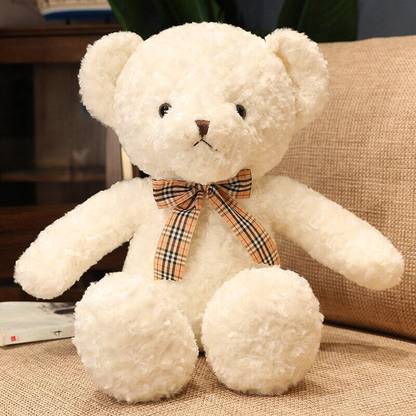 a classic cream teddy bear with a tartan bow